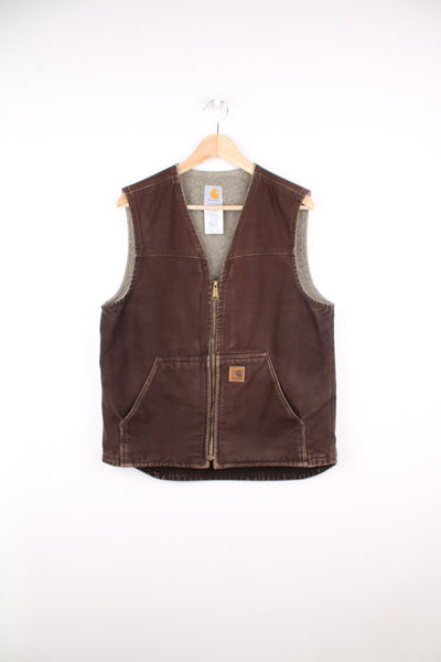 Carhartt Workwear Gilet in a brown colourway, zip up, sherpa lining, and has the logo embroidered on the front pocket.