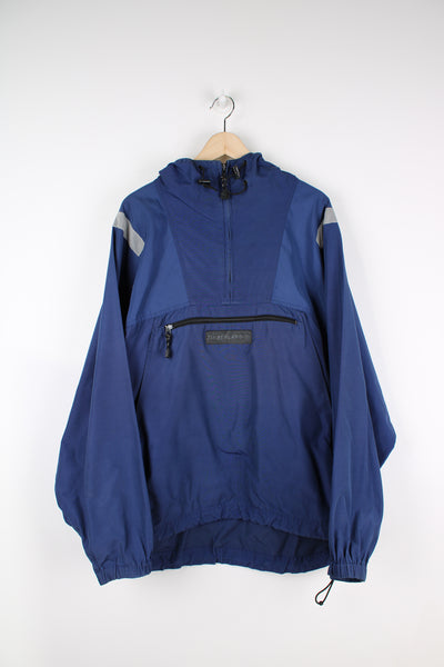 Vintage Timberland pullover jacket in blue, has 3m reflective stripes on the shoulders, multiple pockets, quarter zip up, and has logos embroidered on the front and back.