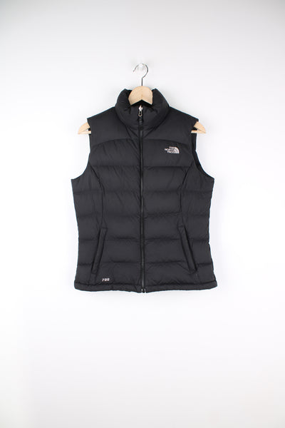 The North Face Face puffer gilet in black, zip up with side pockets, insulated and has logo embroidered logo on the front and back.
