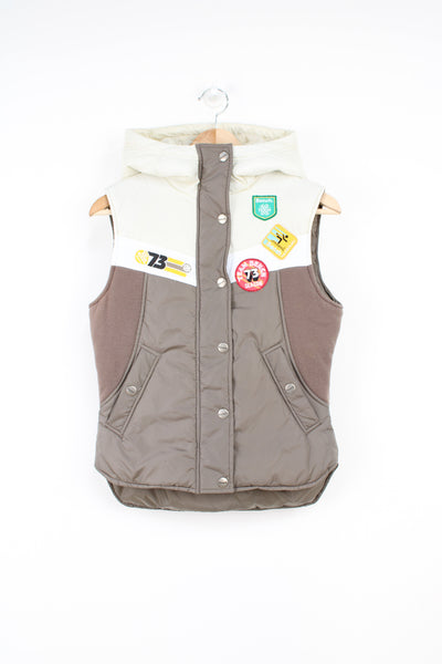 00's Bench, cream and brown style full zip gilet, with 70's inspired embroidered badges on the chest