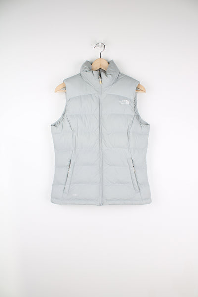 The North Face Face puffer gilet in a grey, zip up with side pockets, insulated and has logo embroidered logo on the front and back.