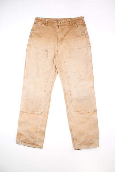 Carhartt Double Knee Jeans in a tan colourway, multiple pockets, and has the logo embroidered on the back pocket.
