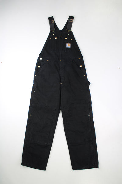 Vintage Carhartt black denim dungarees/ work overalls. Feature red padding on the legs and double knee reinforcement. good condition - Marks on the legs and some fraying to the cuffs (see photos)Size in Label: No Size Label - Measures like a Mens M