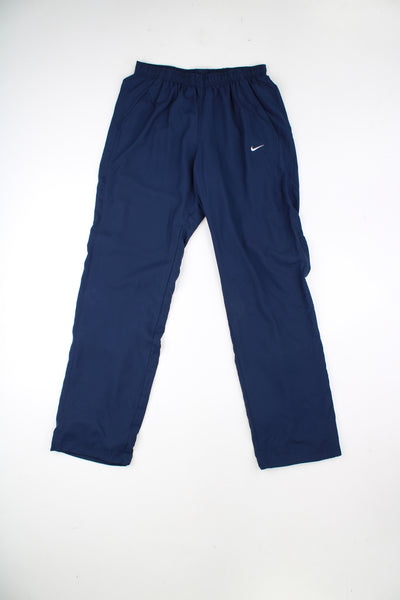 Blue Nike straight leg tracksuit bottoms with elasticated drawstring waist. Features embroidered logo.