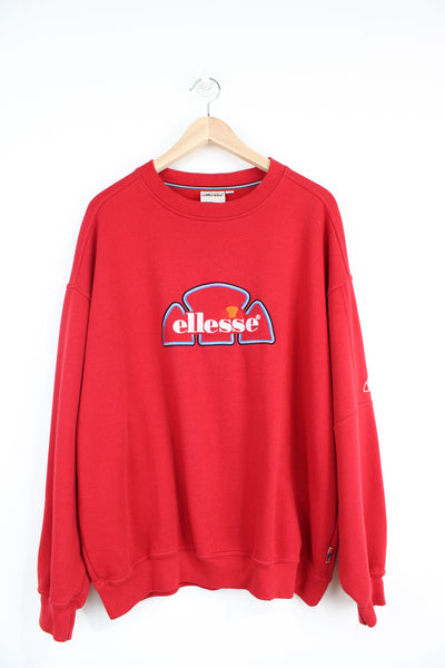 Ellesse red crewneck sweatshirt, with embroidered logo on the chest and sleeve