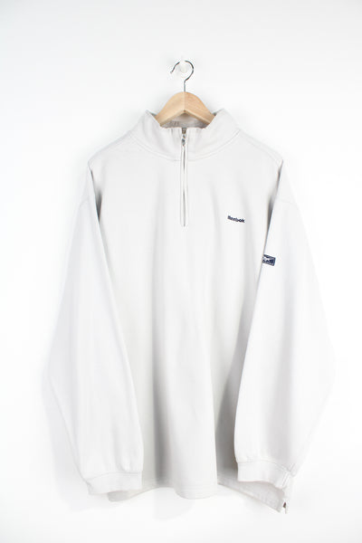 Off white Reebok 1/4 zip sweatshirt with embroidered spell-out logo on the chest