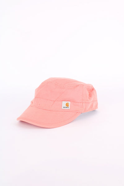 Carhartt pink baker boy style cap with patch logo on the front. Has an adjustable strap at the back. 