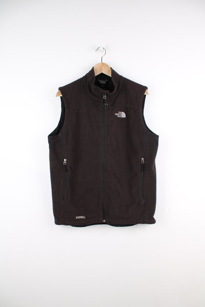 The North Face Fleece Vest in a black colourway, zip up, side pockets, and has the logo embroidered on the front and back.