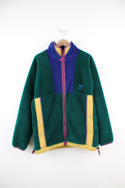 Vintage Helly Hansen Fleece in a green, purple, and yellow colourway, zip up, side pockets, and has the logo embroidered on the front.