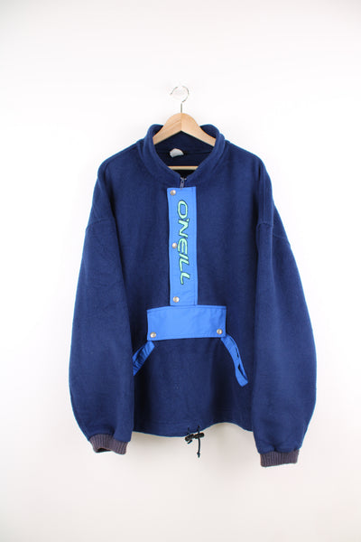Vintage O'Neill Pullover Fleece in a blue colourway, half zip, multiple pockets, adjustable waist and has the logo spell out printed on the front.