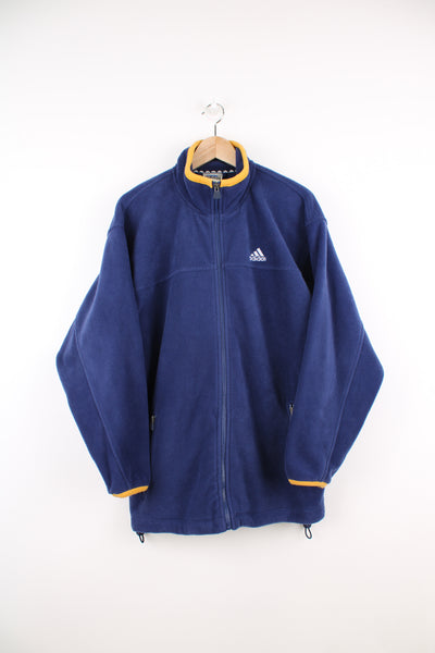 Adidas Fleece in a blue colourway, zip up, side pockets, adjustable waist and has the logo embroidered on the front.