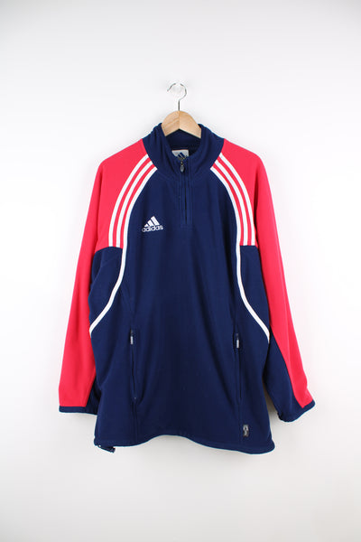 Adidas Fleece in a blue, white and red colourway, quarter zip up, side pockets, adjustable waist and has the logo embroidered on the front and back.