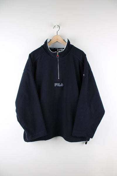 Navy blue Fila 1/4 zip fleece with embroidered logo on the chest, zip up pockets and drawstring waist.