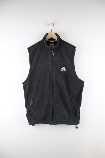 Adidas grey fleece, zip through gilet. features an embroidered logo on its chest and double pockets