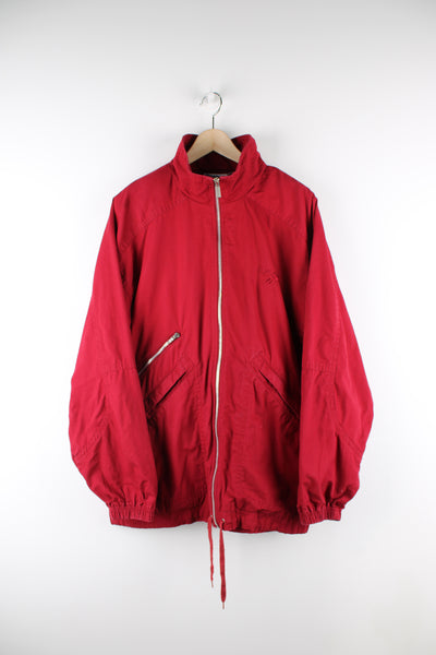 Vintage Reebok lightweight windbreaker jacket in red, zip up, big collar, multiple pockets, has a adjustable waist and logo embroidered on the front and back. 