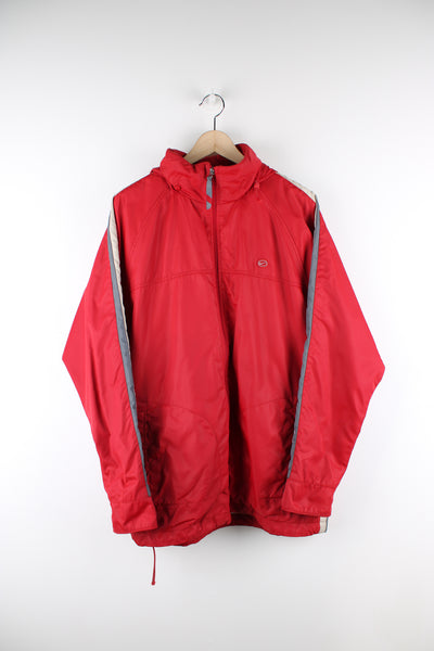 Vintage 00's Nike Cor72z Jacket in red, has white and grey stripes going down the sleeves, zip up, hidden hood and has logo embroidered on the front and back.