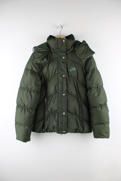 Vintage Nike puffer jacket in green, insulated, detachable hood, zip and button up, has logo printed on the front.