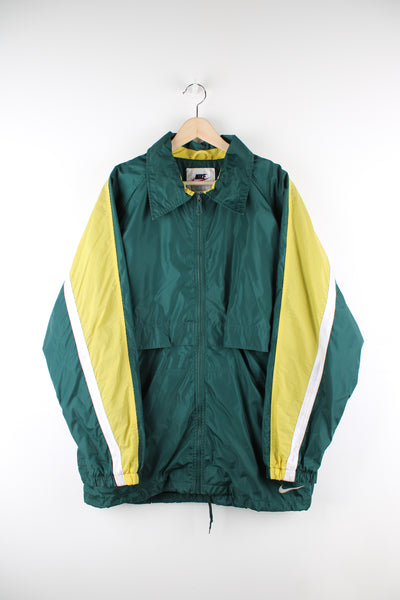 Vintage Nike windbreaker in a green, yellow and white colourway, zip up, mesh lining, and has the logo embroidered on the front and back. 
