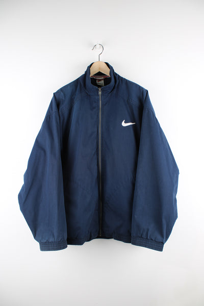 Vintage Nike Coach Jacket in blue, zip up with side pockets, mesh lining and has swoosh logo embroidered on the front. 