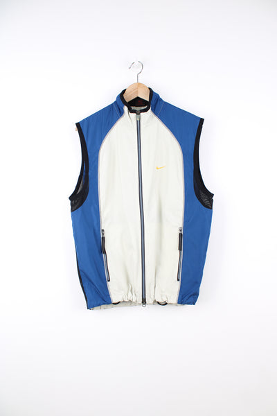 Vintage Nike Lightweight Vest in a white and blue colourway, zip up, 3m reflective lining around the front and back, half mesh material on the back, and has the swoosh logo embroidered on the front.