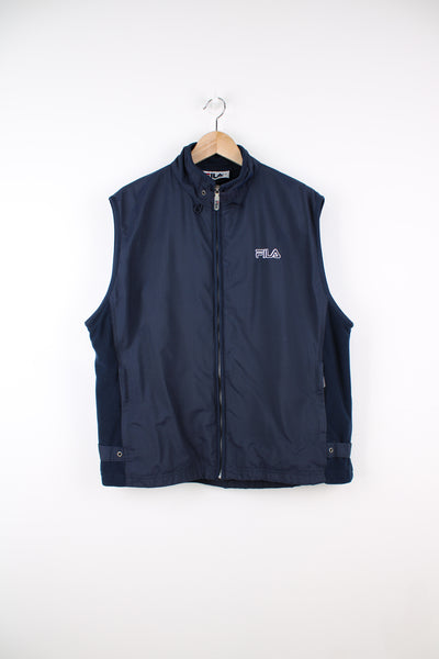 Vintage Fila Lightweight Gilet in a blue colourway, zip up, side pockets, and has the logo embroidered on the front.