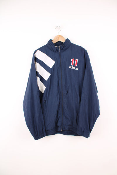 Adidas Tracksuit Jacket in a blue, white and red colourway, zip up, side pockets, hidden hood, Denison embroidered on the back as well as the logo on the front.