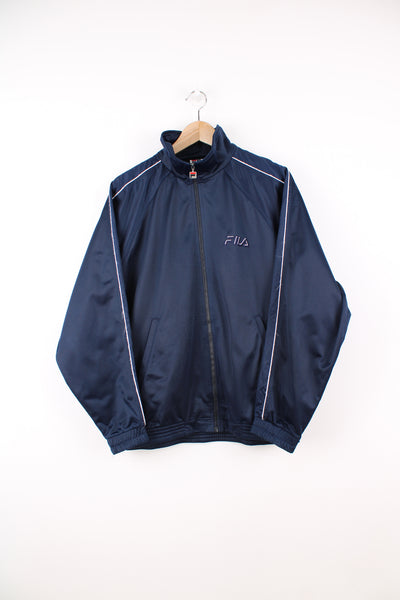 Fila Tracksuit Top in a blue colourway, zip up, side pockets, and has the logo embroidered on the front.