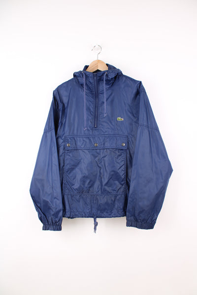 Vintage Izod Lacoste, Lightweight Pullover Smock in a blue colourway, half zip, two pouch pockets, hooded, adjustable waist and has the logo embroidered on the front.
