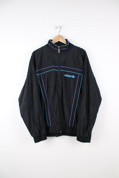Vintage Adidas Tracksuit Jacket in a black colourway, zip up, side pockets, and has the logo embroidered on the front.