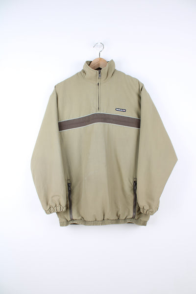 Reebok Pullover Windbreaker in a brown colourway, quarter zip, side pockets, and has the logo embroidered on the front.