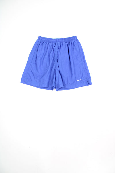 Blue Nike shorts with white embroidered swoosh logo on the leg and elasticated waistband. good condition Size in Label: Womens 8 - 10 (M)