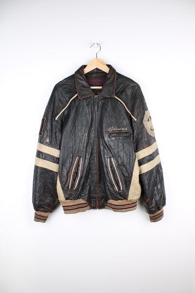 Vintage 1981 Guess all brown leather varsity jacket, features embroidered motif on the back