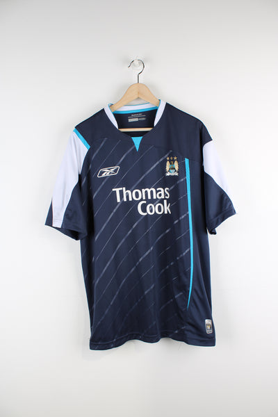 Vintage Manchester City 2005/06, Reebok Away Football Shirt, blue and white colourway, and has printed logos on the front. 