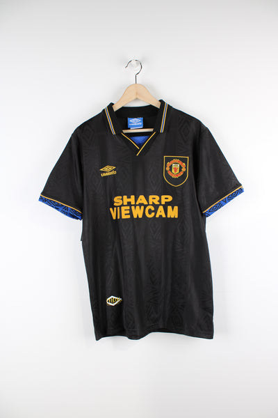 Vintage Manchester United 1993/95, Umbro Away Football Shirt, black and gold colourway, v neck with a collar, and has embroidered logos on the front. 