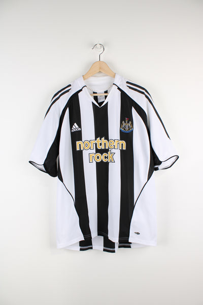Vintage Newcastle 2005/08, Adidas Home Football Shirt, white and black colourway, v neck, and has logos printed on the front. 