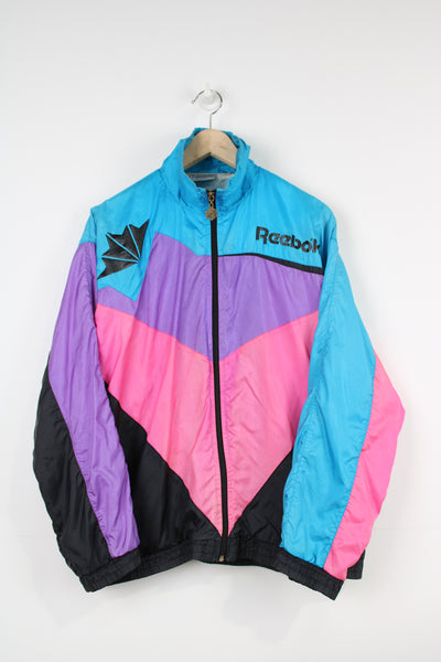 Vintage Reebok blue, purple, pink and black colour block zip through shell jacket with logos on the front and back