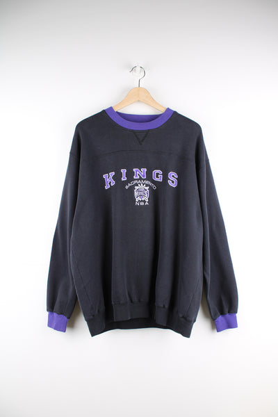 Vintage black and purple Sacramento Kings NBA crewneck sweatshirt by Lee Sport. Features embroidered spell-out logo on the front