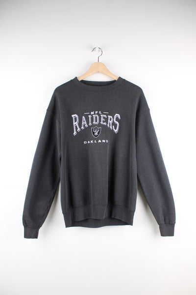 Oakland Raiders faded black sweatshirt by Lee Sport, features embroidered spell-out details on the front