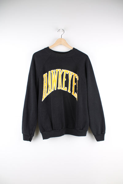 Vintage 90's made in the USA University of Iowa Hawkeyes black crewneck sweatshirt, features printed yellow spell-out details on the front 