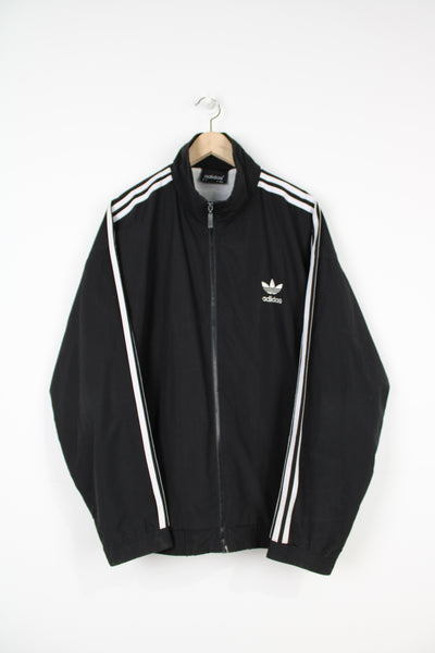 Vintage Adidas black zip through tracksuit top with white three stripe details and embroidered logo on the front