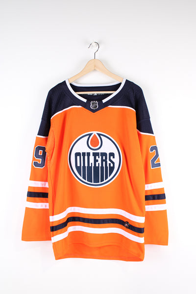 NHL #29 Leon Draisaitl Edmonton Oilers NHL jersey in orange with embroidered lettering and badges on the chest and arms.   good condition  Size in Label:   Mens 46 - Measures like a Mens M
