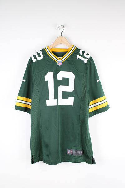 Green Bay Packers, Nike NFL Jersey, green, white and yellow team colourway, Aaron Rodgers number 12 printed on the back, as well as logos on the front. 