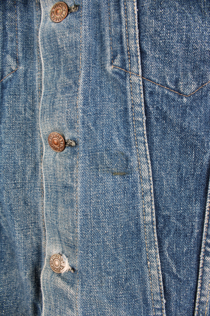 Vintage Levi's denim trucker jacket button up, double chest pockets, and has orange tab logo embroidered on the chest. 