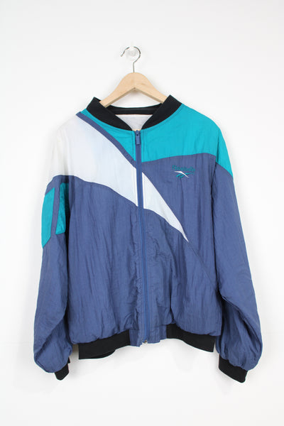 Vintage 90's Reebok blue colour block zip through shell jacket with embroidered logo on the chest