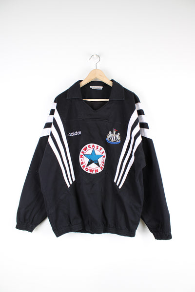 Vintage Newcastle 1995/96 Adidas cotton training top in black and white team colourway, v neck with cuffed arms and waist line, has embroidered logos on the front and back.