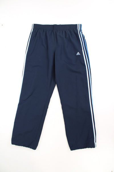 Vintage Adidas tracksuit bottoms in blue with embroidered blue logo and three stripe detail down the legs. They also feature an elasticated waistband and 1/4 zips on the legs. good condition Size in Label: Mens L 