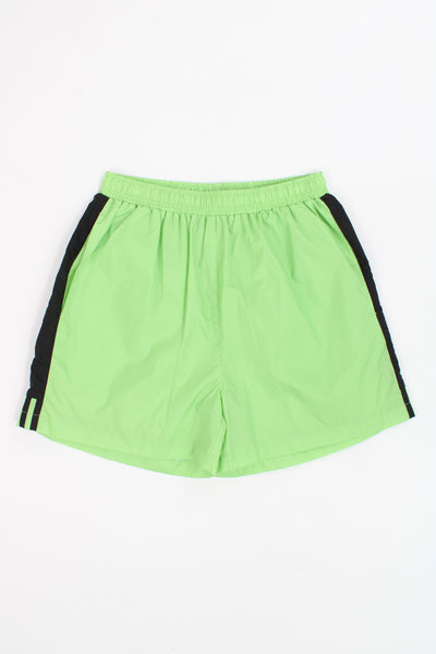 Vintage Adidas neon green nylon sport shorts with white three stripe details on the leg