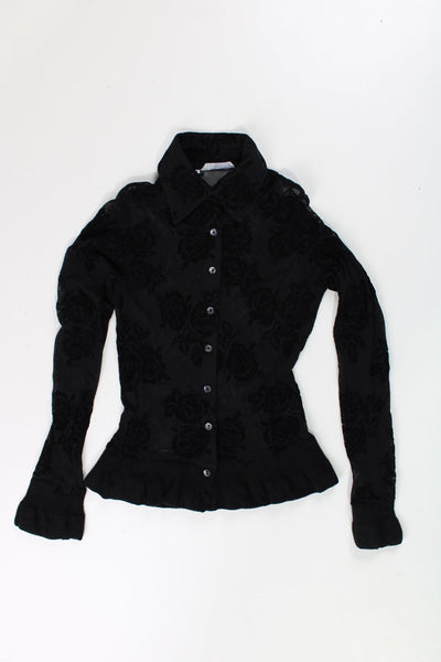 Sheer black shirt with flocked velvet rose detail. Has elasticated hem and cuffs.  good condition  Size in Label:   No Size - Measures like a size S/M (measurements taken un-stretched, made from stretchy material so could fit multiple sizes)  Our Measurements:  Chest: 17 inches  Length: 21 inches