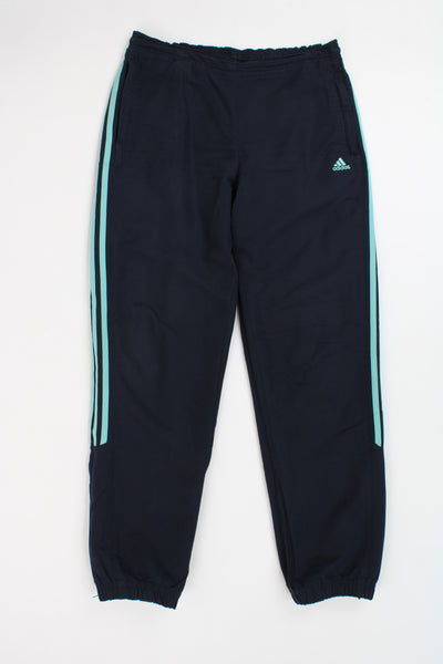 Adidas navy blue and turquoise three stripe tracksuit bottoms with elasticated waist, zip up cuffs and embroidered logo on the pocket