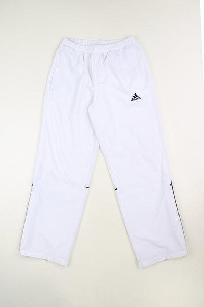 Vintage white Adidas tracksuit bottoms with elasticated waistband and 1/4 zips on the side of the ankles. Features embroidered logo and three stripe detail on the leg good condition - faint mark near the bottom of the right leg. Size in Label: 30 - Measures like a Mens S